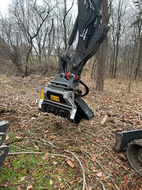 Tree grinder attachment for a Mecalac 6MCR.